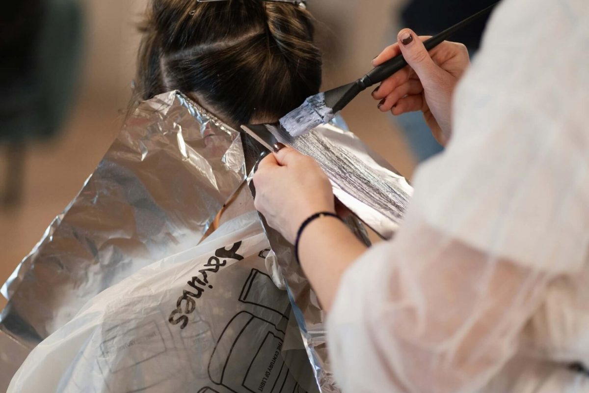 Rear view of a lady having foil highlights applied